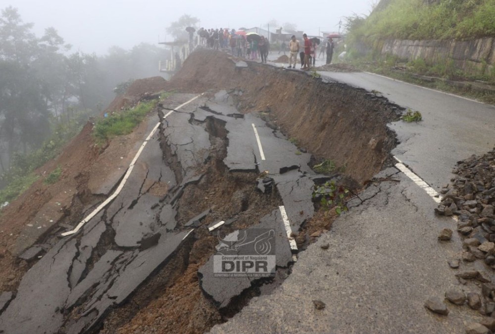 A massive landslide causes a severe road collapse along National Highway 702A at New Colony, Zunheboto, completely disrupting vehicular movement as locals and officials gather to assess the damage. (DIPR Photo)